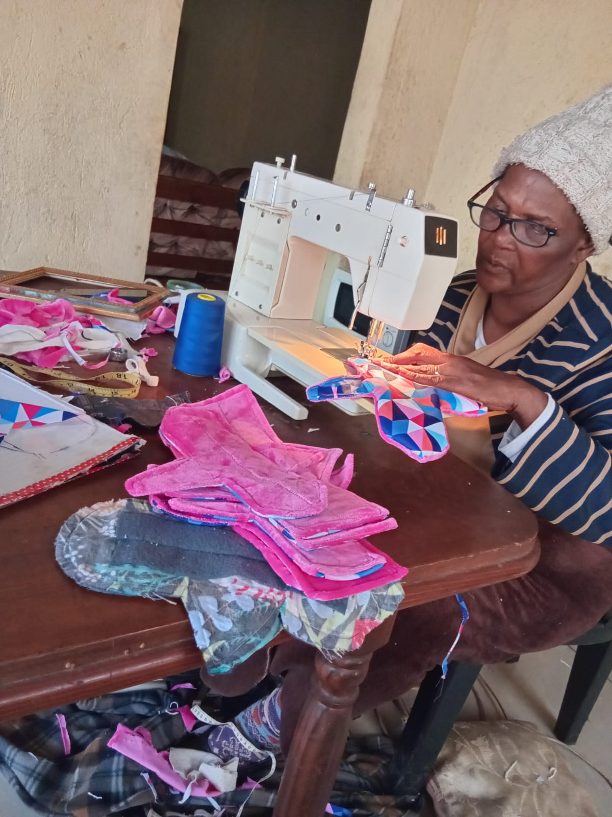 Seamstress busy with reuable sanitary pad production